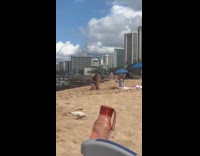 Girl takes picture of mother at beach Part 2