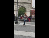 Blonde woman grey shirt dance Washington arch