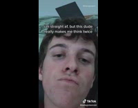 Guy sits black chair covers phone camera