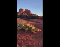 Woman in a red dress poses at the canyon