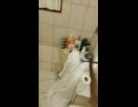 Girl walks into bathroom gold necklace 