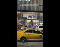 Sequin girl stands top of car roof