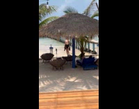 Woman bikini with cap poses on beach