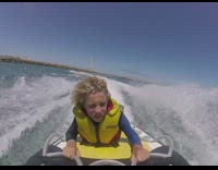 Little blonde kid on raft falls off into water