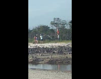 Guy puts orange traffic cone over head 