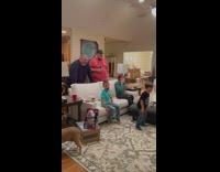 Guy talks in front of family for game