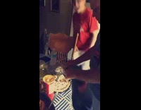 Guy tricks grandpa cake on table 