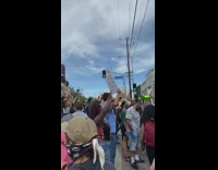 Peaceful protest people hold hands up helicopter 