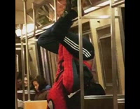(DUPLICATE) man in spiderman outfit hangs from subway ceiling 