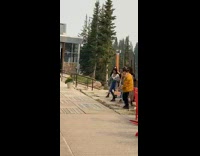 Six girls pose by black love sculpture 