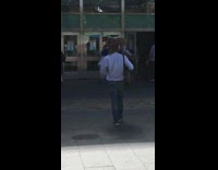 Guy with bag walks with dog on shoulders