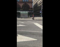 Man covered in red paint crosses street