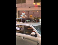 Woman rabbit eats kneel on car roof