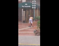 White shorts guy kettlebell exercise sidewalk rain 