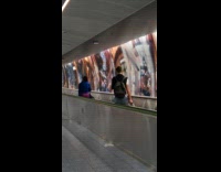 Collab IITW - Woman in autowalk filmed by man behind airport