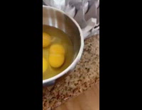 Guy cracks an egg with two yolks and asks google what it means