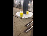 MTA worker using pressure washer to fill bucket