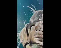 Girl paints grey seal on blue canvas 