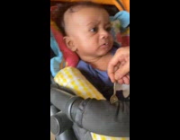 Baby fed by mom spits out food