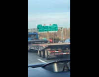 Tiny toy ATV on flatbed trailer of big rig truck
