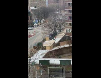 Three kids run down sidewalk together