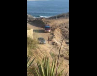 Woman dress poses places phone car roof