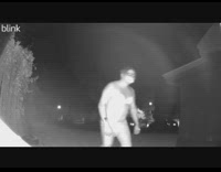 Man in bra and diaper sneaks up to house