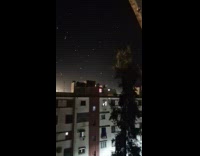 Stadium lights reflect on seagulls look like stars