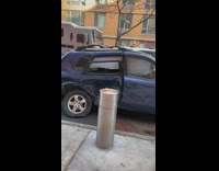 Smashed blue car on the side of the street