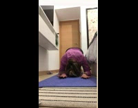Woman fails a handstand while practicing yoga