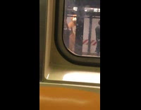 Monkey suit costume dances in subway station recorded from inside train