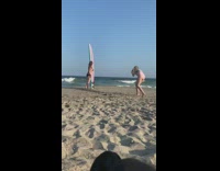 Woman black bikini bikini side pose surfboard beach