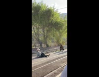 Woman in jean jacket poses in the middle of the railway