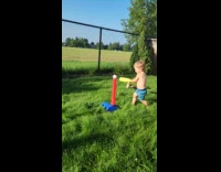 Kid hits ball with bat to camera