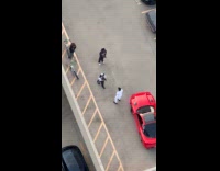 Man rooftop video shoot with red car