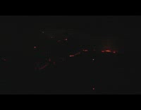 Red fire flames in distance dark mountain 