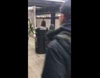 man sitting on subway bench brushing teeth