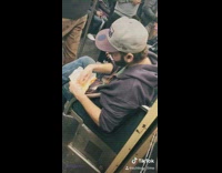 Guy eats food and scrapes for leftovers on subway train