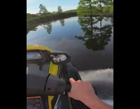 Guy rides yellow jet ski across lake