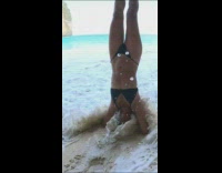 (DO NOT CLAIM - LPE360) Woman in black bikini hand stand beach waves Fail