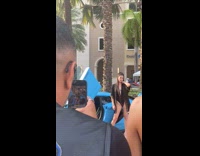 Collab IITW - Woman in black bikini poses in front of the blue sports car