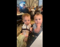 Woman cheers and lets little boy drink 