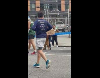 NYC Marathon woman and dog with free high five sign