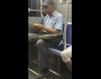 Man eats a orange and the orange peel on subway train