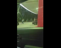 Man sit besides black car pictorial gasoline station