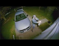 Man sprays and jumps to hit the spider with slippers on the wall