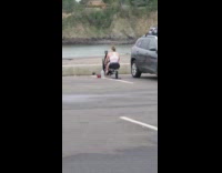 Woman working out on a random rowing machine set up in a parking lot