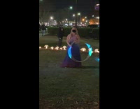 Woman spin LED hula hoop night mushrooms
