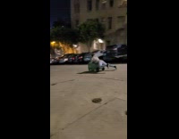 Man rides the garbage bin downhill and sparks came out