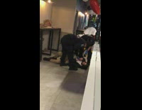 Drunk guy gets woken up by EMT in a taco bell and stands up